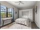 Bedroom with murphy bed and desk area, luxury vinyl flooring, and bright natural light at 584 Mast Dr, Bradenton, FL 34208