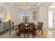 Dining room featuring modern chandelier, large window, and stylish furniture at 584 Mast Dr, Bradenton, FL 34208