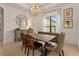 Dining room featuring modern chandelier, large window, and stylish furniture at 584 Mast Dr, Bradenton, FL 34208