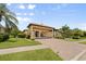 Beautifully landscaped single-Gathering home with a porte-cochere and a brick driveway at 584 Mast Dr, Bradenton, FL 34208