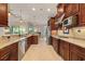 Bright kitchen featuring stainless appliances, granite countertops, and tile flooring at 584 Mast Dr, Bradenton, FL 34208