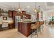 A gourmet kitchen featuring dark cabinetry, pendant lighting, and an island with seating at 584 Mast Dr, Bradenton, FL 34208