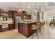 Open-concept kitchen with an island, granite counters, and seating area at 584 Mast Dr, Bradenton, FL 34208