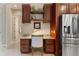 Granite desk space off kitchen with stainless steel fridge at 584 Mast Dr, Bradenton, FL 34208