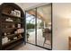 Cozy living room featuring a decorative bookshelf with a view of the screened-in pool and patio at 584 Mast Dr, Bradenton, FL 34208