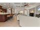 Open living room showcases coffered ceilings, pendant lighting above the kitchen island, and hardwood bar stools at 584 Mast Dr, Bradenton, FL 34208