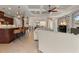Open-concept living room features a coffered ceiling, tile flooring, and seamless flow to kitchen at 584 Mast Dr, Bradenton, FL 34208