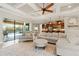 Open-concept living area with elegant furniture, leading to an outdoor patio and kitchen at 584 Mast Dr, Bradenton, FL 34208