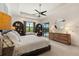 This main bedroom offers trey ceilings and backyard pool access and built-in shelving units at 584 Mast Dr, Bradenton, FL 34208