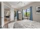 Serene main bedroom boasts a sliding glass door to the pool area, a decorative rug, and ambient natural light at 584 Mast Dr, Bradenton, FL 34208