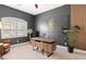 Stylish home office with dark walls, a modern wooden desk, unique lion wall art, and a large potted plant at 584 Mast Dr, Bradenton, FL 34208