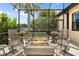 Screened lanai showcasing an outdoor fireplace and outdoor seating at 584 Mast Dr, Bradenton, FL 34208