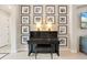 Elegant piano with framed photos creates a cozy, inviting atmosphere in this home at 584 Mast Dr, Bradenton, FL 34208