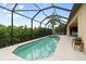 Relaxing screened-in swimming pool with a spa, covered patio, and seating for outdoor enjoyment at 584 Mast Dr, Bradenton, FL 34208