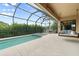 Relaxing screened-in swimming pool with a spa, covered patio, and seating for outdoor enjoyment at 584 Mast Dr, Bradenton, FL 34208