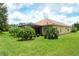 Lush backyard featuring tropical palm trees and a view of a screened in lanai at 6214 45Th E Ln, Bradenton, FL 34203