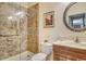 Bathroom featuring tile shower with glass enclosure, framed vanity mirror, and ceramic tiled accents at 6214 45Th E Ln, Bradenton, FL 34203