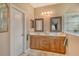 Bathroom with double sinks, framed mirrors, and vanity cabinets offering organized storage at 6214 45Th E Ln, Bradenton, FL 34203