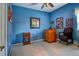 Carpeted bedroom featuring blue walls, wood furnishings, and large window offering natural light at 6214 45Th E Ln, Bradenton, FL 34203