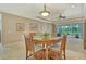 Cozy dining area featuring a wooden table, comfortable seating, and views of the outdoor living space at 6214 45Th E Ln, Bradenton, FL 34203