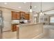 Open kitchen with granite countertops and stainless steel appliances, leading into the living room at 6214 45Th E Ln, Bradenton, FL 34203