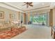Spacious living room with neutral carpet and ample natural light, leading to a screened-in patio at 6214 45Th E Ln, Bradenton, FL 34203