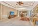 Open-concept living room featuring a ceiling fan, dining area, and modern kitchen with stainless appliances at 6214 45Th E Ln, Bradenton, FL 34203