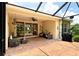 Covered patio area with stamped concrete, outdoor furnishings, and sliding glass door access to home's interior at 6214 45Th E Ln, Bradenton, FL 34203
