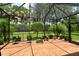 Covered screened in patio area with beautiful stamped concrete and a lush tropical landscape at 6214 45Th E Ln, Bradenton, FL 34203