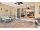 Covered patio with stamped concrete, ceiling fan and outdoor furniture, with access to the home interior at 6214 45Th E Ln, Bradenton, FL 34203