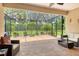 Relaxing screened-in patio with comfortable seating and lovely views of the landscaped yard at 6214 45Th E Ln, Bradenton, FL 34203