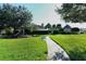 Community playground on a lush green lawn with mature trees and walkways for neighborhood enjoyment at 6214 45Th E Ln, Bradenton, FL 34203