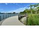 Scenic lakeside walkway with metal railing provides stunning views in this beautiful community at 6224 Isla Del Ray Ave, Sarasota, FL 34240
