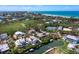 Scenic aerial shot featuring waterfront homes, community tennis courts, and the Gulf Coast beaches in the distance at 663 Penfield St, Longboat Key, FL 34228