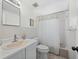 This bright bathroom features standard vanity with an oval sink, tile floors, and tiled shower at 663 Penfield St, Longboat Key, FL 34228