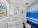 Bright bathroom features linoleum flooring, a blue shower curtain, and a standard vanity at 663 Penfield St, Longboat Key, FL 34228