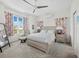 Bright bedroom with stylish furniture, large window, and a ceiling fan creating a cozy and inviting space at 663 Penfield St, Longboat Key, FL 34228