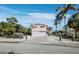 Coastal home with shutters, elevated construction, tropical foliage, and a shell driveway at 663 Penfield St, Longboat Key, FL 34228