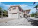 Two-story coastal home with shutters, elevated construction, and a shell driveway at 663 Penfield St, Longboat Key, FL 34228