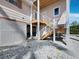 Elevated coastal home with white gravel landscaping, and stairs leading to entrance at 663 Penfield St, Longboat Key, FL 34228