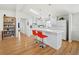 Bright kitchen features stainless appliances, a breakfast bar with seating, and wood-look flooring at 663 Penfield St, Longboat Key, FL 34228