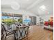 Bright living space featuring a dining area, hardwood floors, and seamless access to an outdoor balcony at 663 Penfield St, Longboat Key, FL 34228