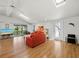 Bright and airy living room with vaulted ceilings, skylights, hardwood floors, and seamless access to the outdoors at 663 Penfield St, Longboat Key, FL 34228