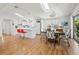 Open-concept living space featuring a modern kitchen with a breakfast bar, and a dining area with lots of light at 663 Penfield St, Longboat Key, FL 34228