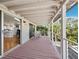 An outdoor covered porch has chairs, an exterior railing, and sliding door access to the kitchen at 663 Penfield St, Longboat Key, FL 34228