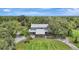 Expansive aerial view of home featuring stone accents, a manicured lawn and a long driveway at 6633 Old Ranch Rd, Sarasota, FL 34241