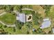 Overhead shot revealing the home's layout, pool area, and outbuildings surrounded by verdant trees at 6633 Old Ranch Rd, Sarasota, FL 34241