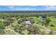 Serene aerial perspective of property with multiple homes set amid verdant grounds and mature trees at 6633 Old Ranch Rd, Sarasota, FL 34241