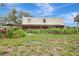 View of the large barn with land and tractor in view at 6633 Old Ranch Rd, Sarasota, FL 34241