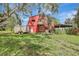 Exterior view of the red barn featuring wooden balcony and stairs at 6633 Old Ranch Rd, Sarasota, FL 34241